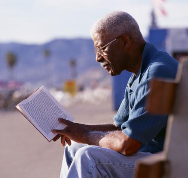 Man with glasses reading a book