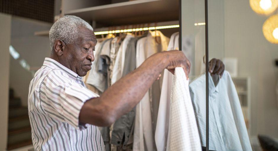 Man looking at clothes in his closet