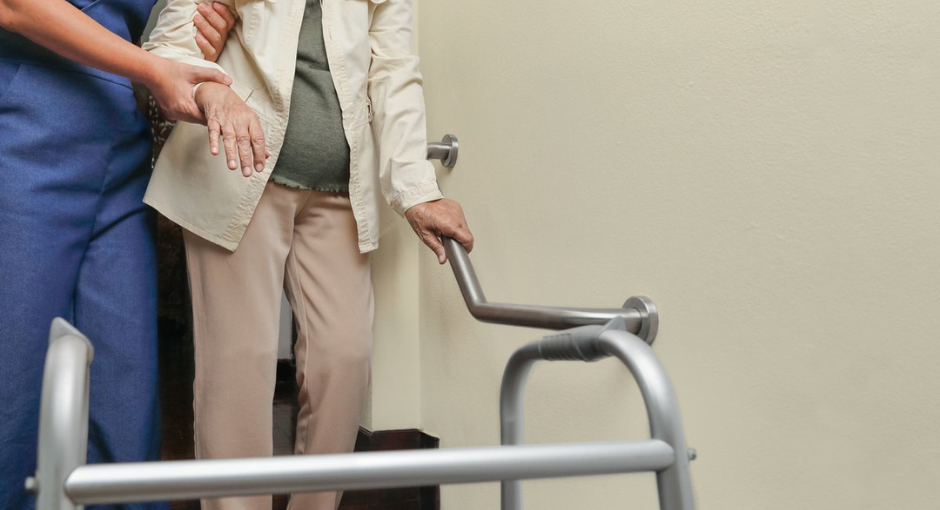 Nurse assisting someone with a walker