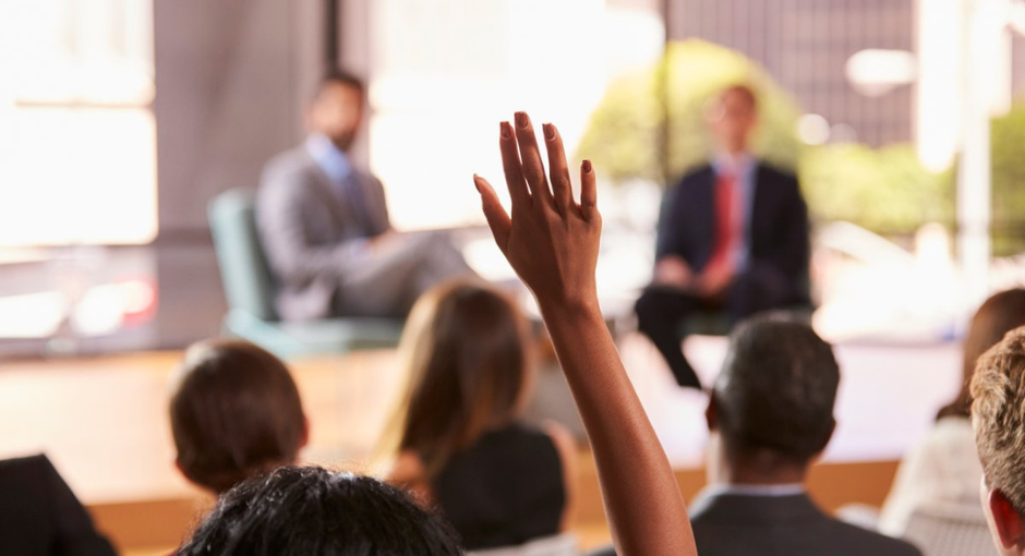 raising hands in a conference