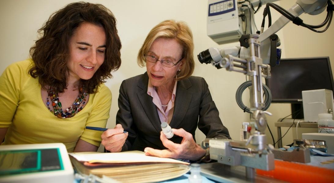 Two women studying research