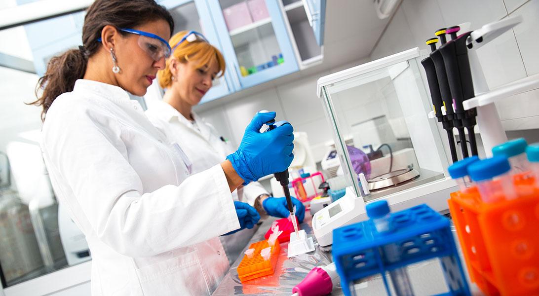 Researchers testing vials in a lab