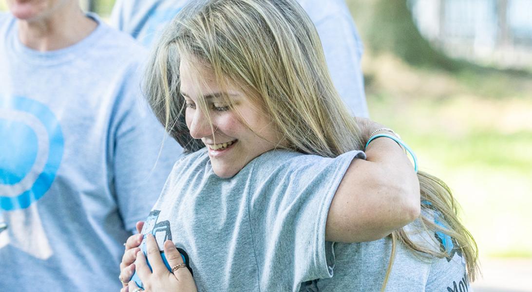 Two people hugging at a Moving Day walk