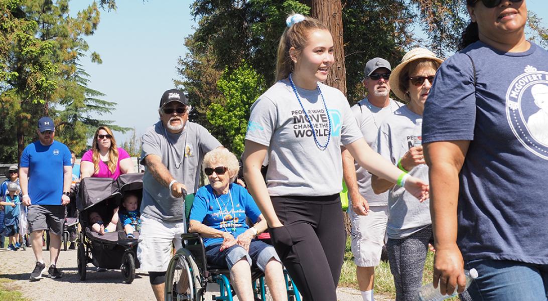 People walking and riding in wheelchairs at Moving Day