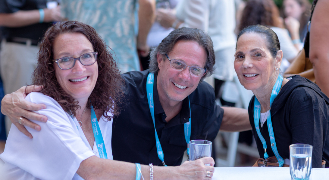 Two women and a man posing for a picture at the volunteer summit