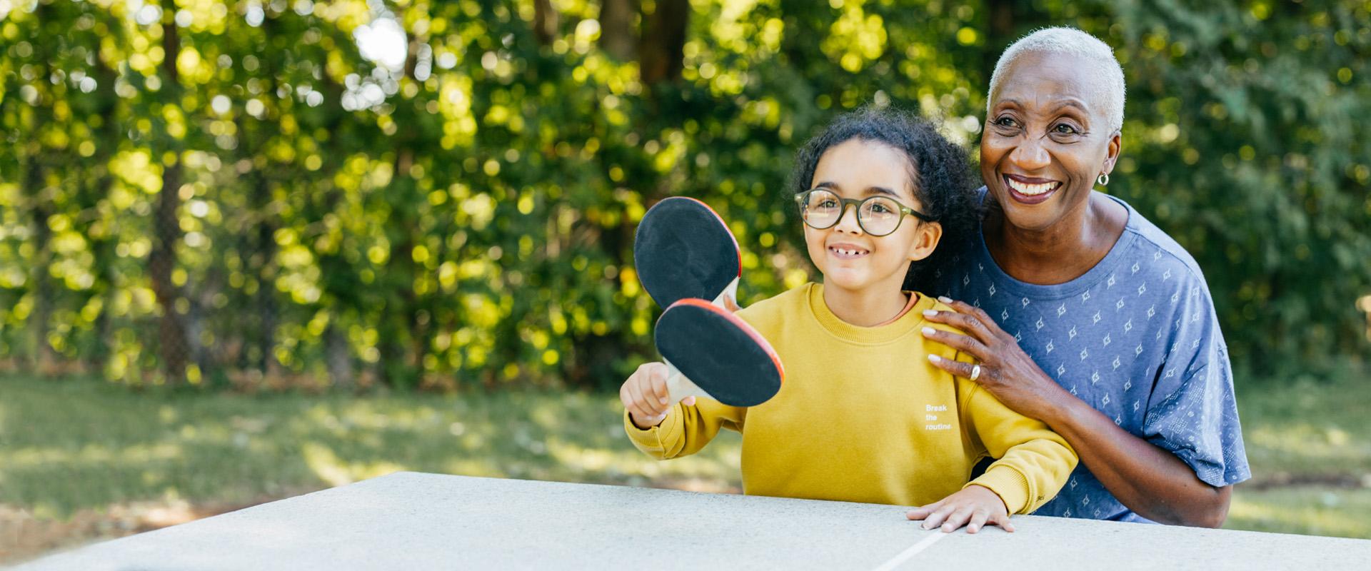 Grandma playing ping pong with granddaughter