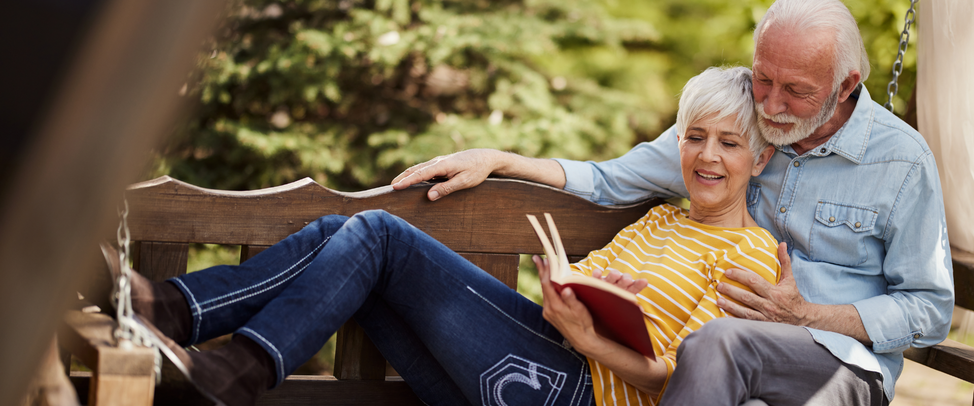 Couple reading a book on outdoor swing