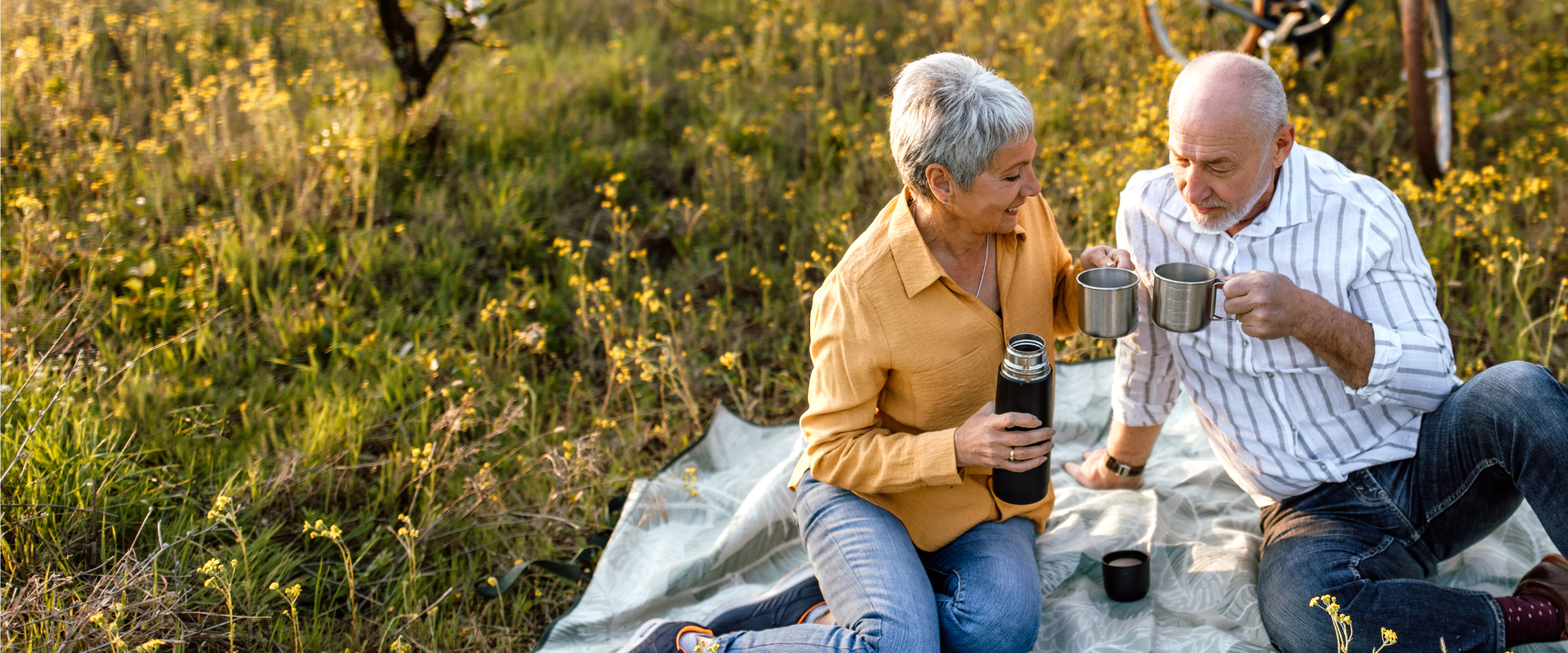 Couple drinking coffee outside on picnic