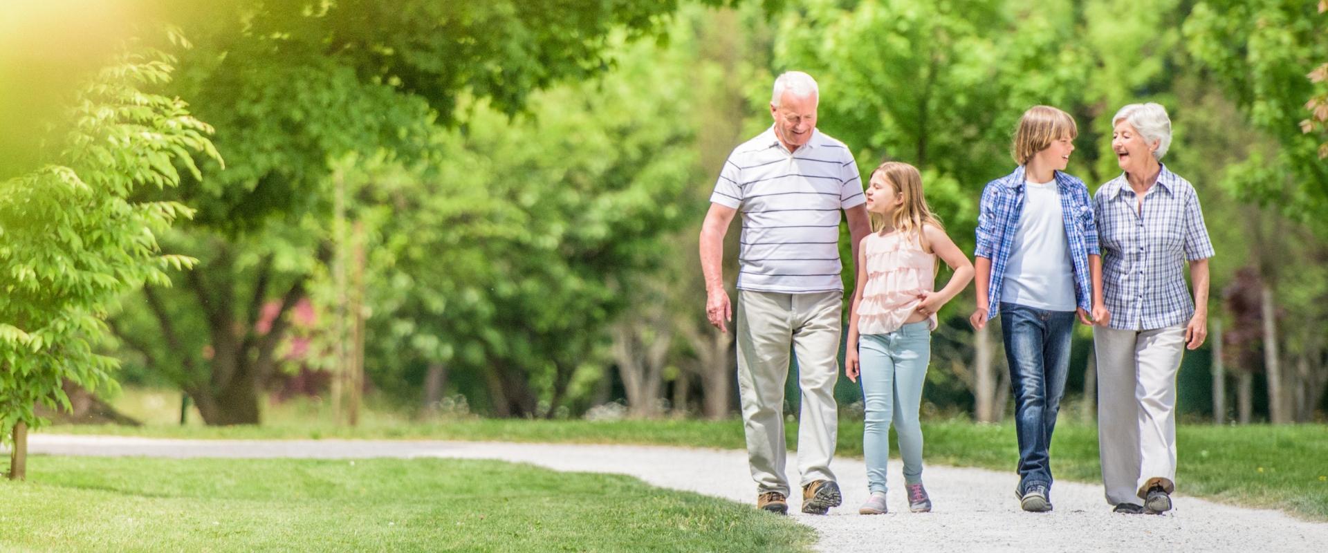 Senior couple walking outside with their grandkids