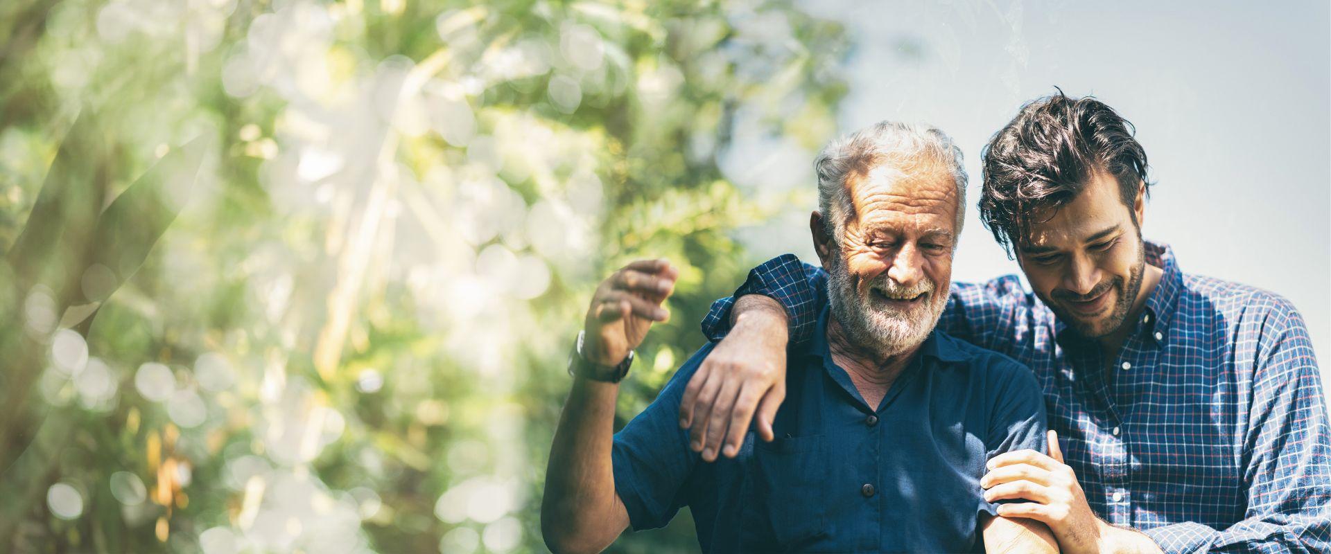 Adult son with his arm around his father 