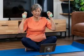 Woman exercising at home with tablet