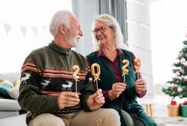 Couple holding 2-0-2-3 signs