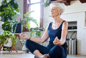 Woman meditating in her livingroom