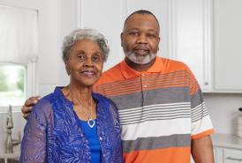 Black son with his arm wrapped around his mother