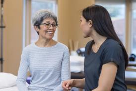 Physical therapist talking with her patient 