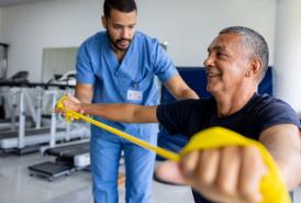 Man doing physical therapy exercises using a stretch band