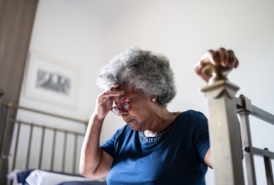 Older woman hunched over in pain