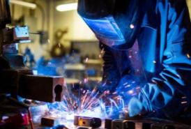 Welder wearing full gear and welding something