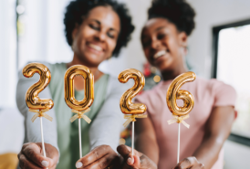 Mother and daughter hold number 2026 new year