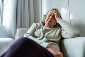 Women sitting on couch in pain