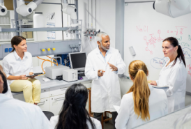 A group of researchers talking in front of white board