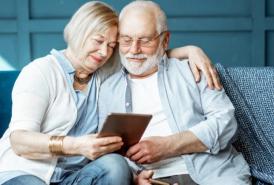 Couple sitting on the couch on a tablet