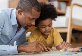 Father reading a book with daughter