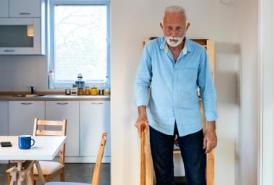 Man using cane standing still in dinning room