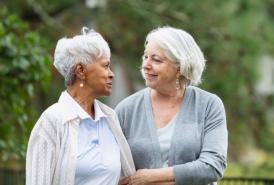 Two friends walking together, showing support