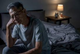 Man sitting in bed cannot sleep