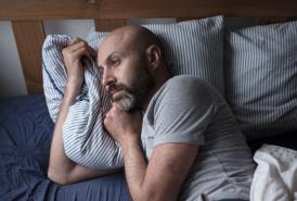 Man struggling to sleep