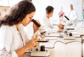 Scientist looking at microscope