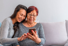 Older and younger women using a smart phone