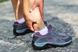 grasping foot in pain