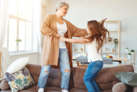 Grandmother dancing with granddaughter