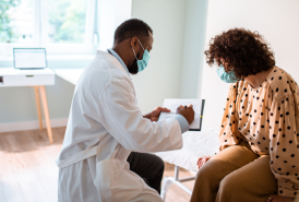 Masked Doctor checking patient