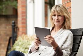 Woman using tablet outside