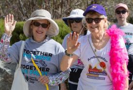Women waving as they walk for Parkinson's Moving Day
