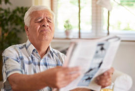 Man struggling to read