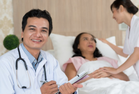 Doctor with patient in a hospital bed