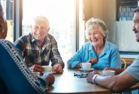 Senior friends talking over coffee