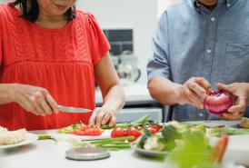 Two people preparing a meal together