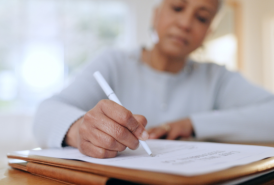 cropped image of an older lady filling out a survey