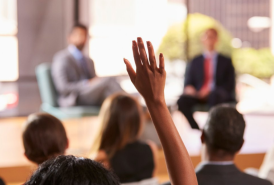 raising hands in a conference