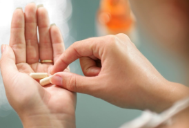 Woman holding a pill