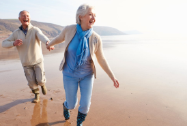 2 people walking on the beach