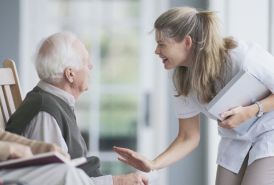 Older man talking to nurse