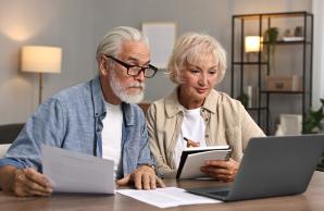 Couple looking at a laptop and paperwork