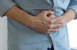 Man holding stomach in pain