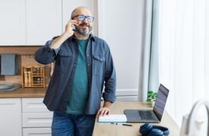 Man talking on his phone in the kitchen